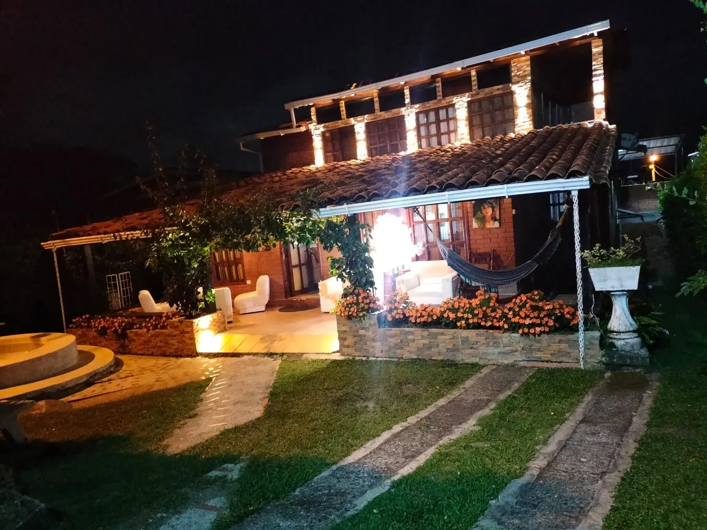Fachada del Hostal Campestre El Galeno iluminada al anochecer