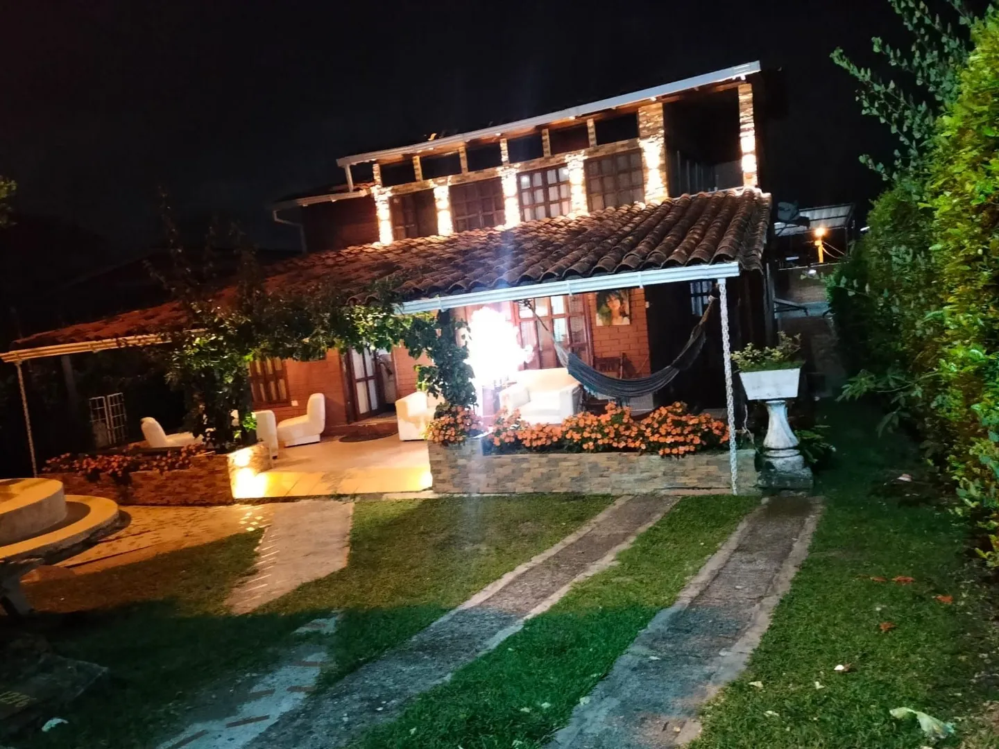 Fachada del Hostal Campestre El Galeno con jardín y hamaca, en Calima El Darién